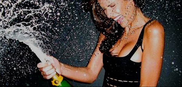 woman spraying champagne